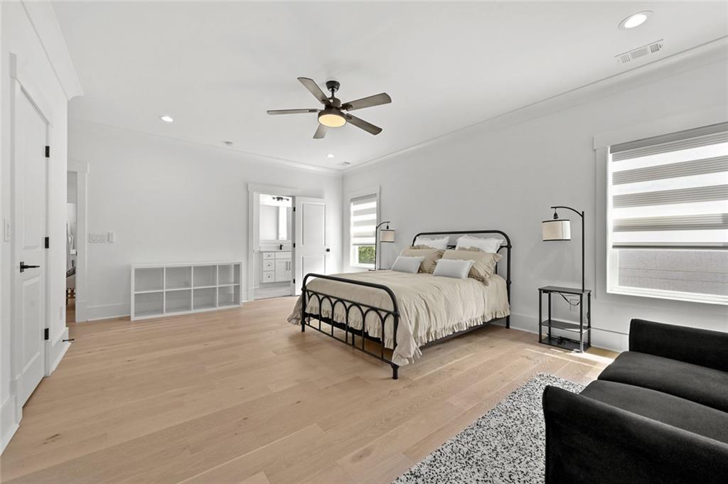 2694 Thompson Mill Road Buford, GA 30519 - Photo 58 of 70 a spacious bedroom with a bed a window and a couch