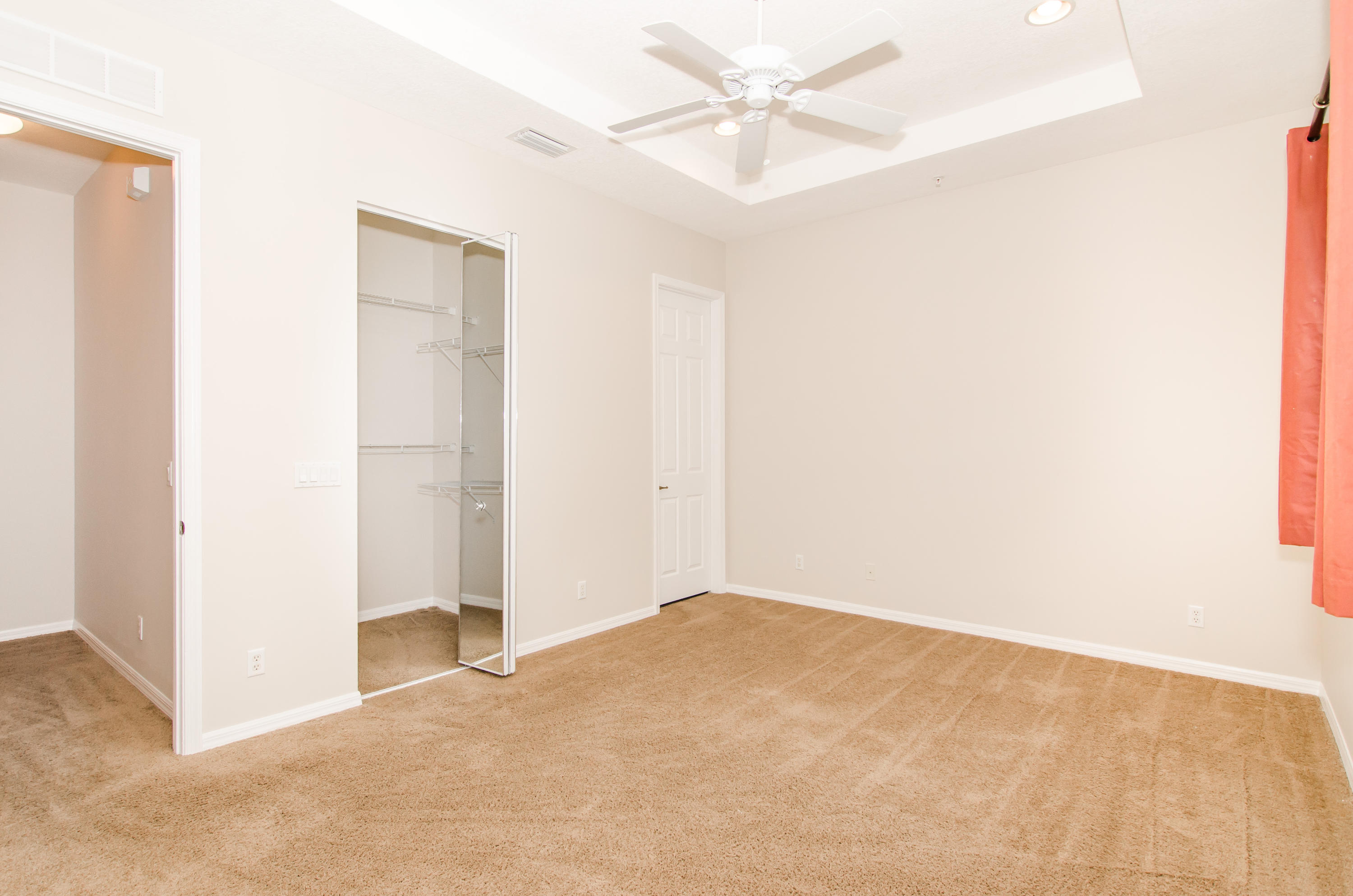4281 East Main Street Jupiter, FL 33458 - Photo 14 of 37 an empty room with a ceiling fan