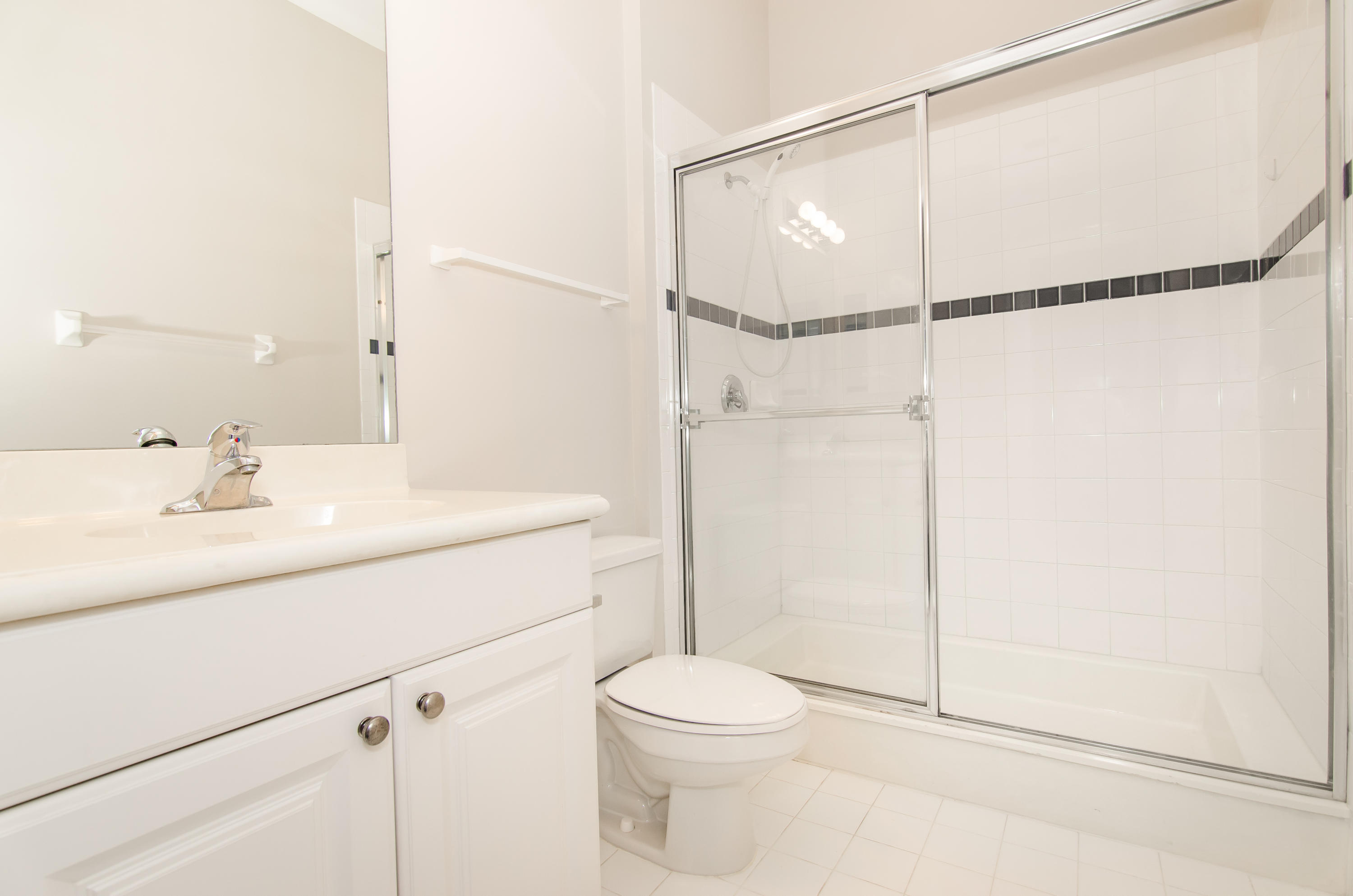 4281 East Main Street Jupiter, FL 33458 - Photo 30 of 37 a bathroom with a shower sink vanity mirror and toilet