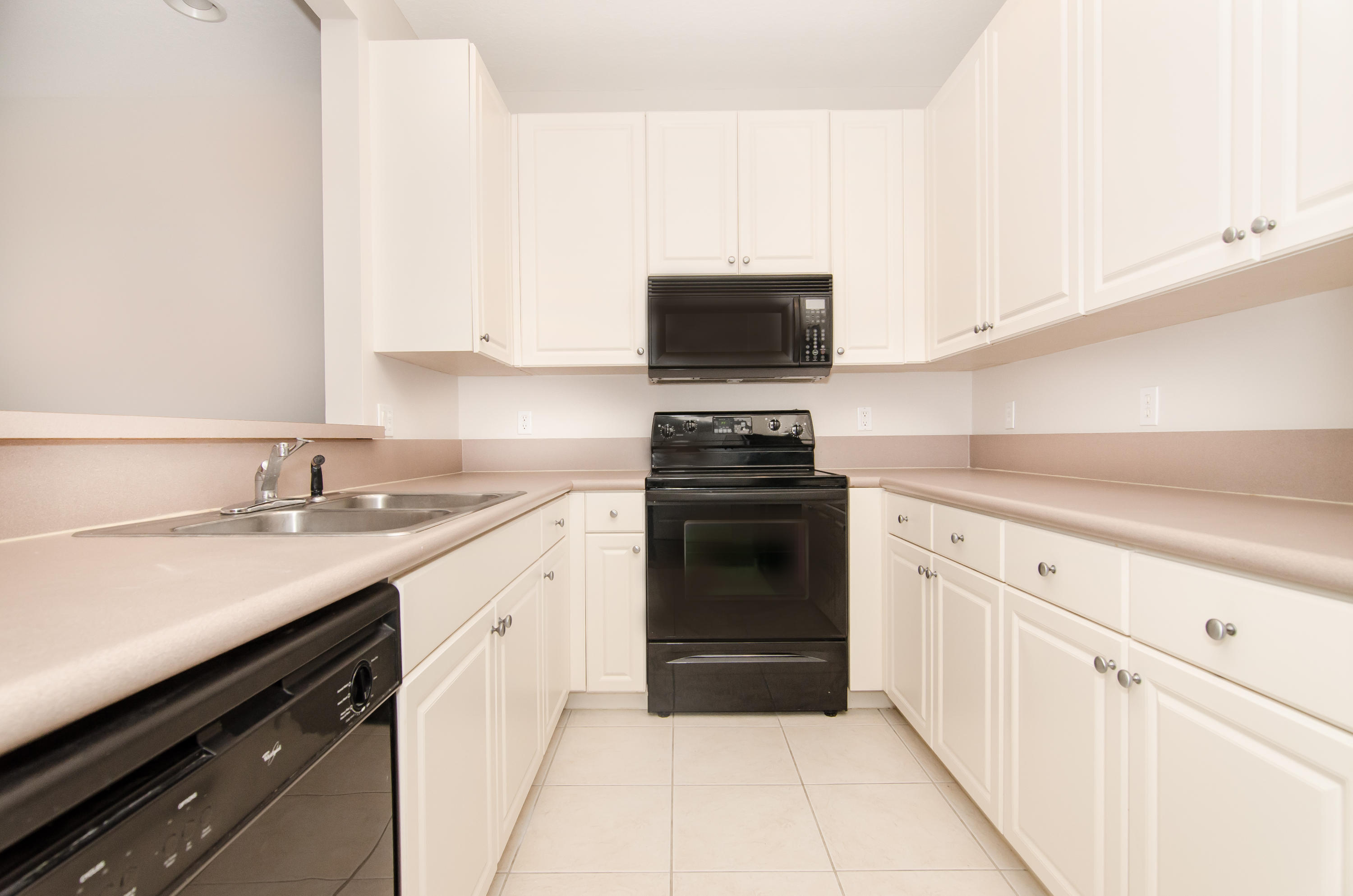 4281 East Main Street Jupiter, FL 33458 - Photo 3 of 37 a kitchen with a sink stove and microwave