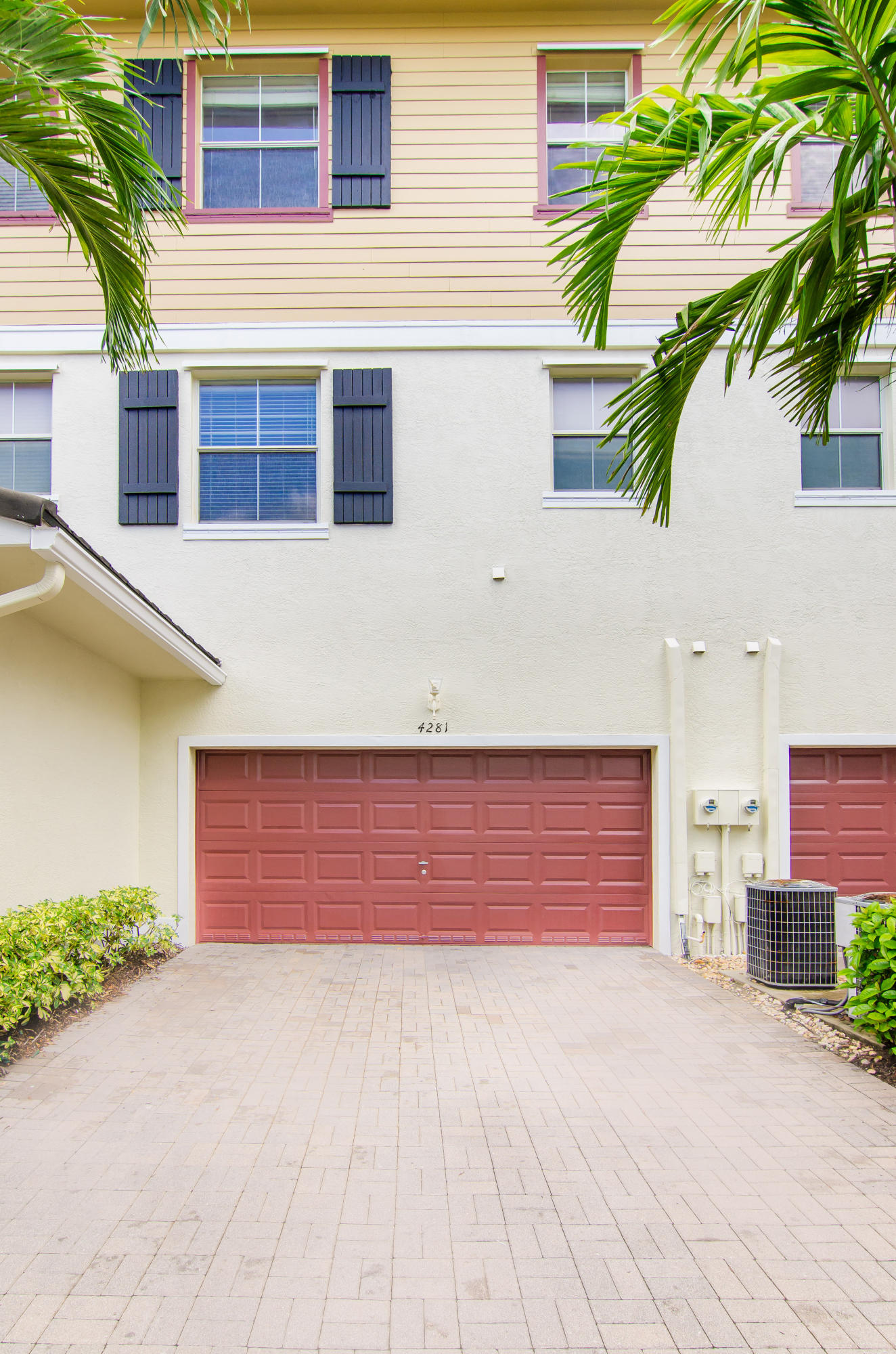 4281 East Main Street Jupiter, FL 33458 - Photo 31 of 37 a front view of a house with a yard and garage