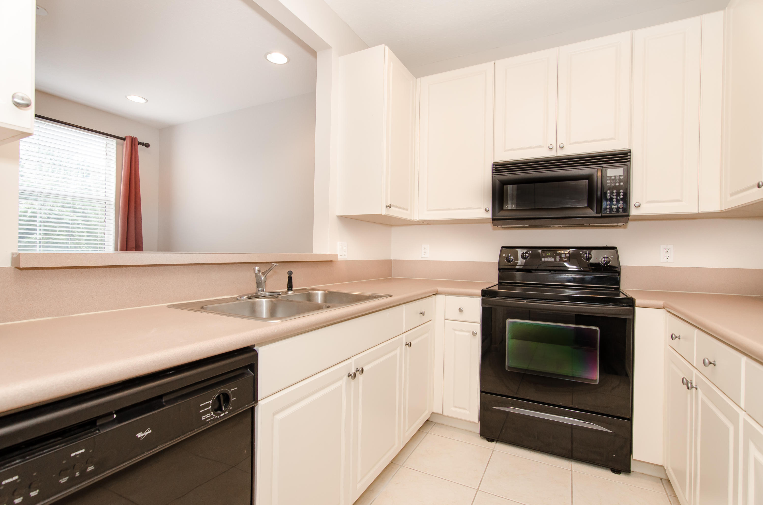 4281 East Main Street Jupiter, FL 33458 - Photo 5 of 37 a kitchen with a sink stove and microwave