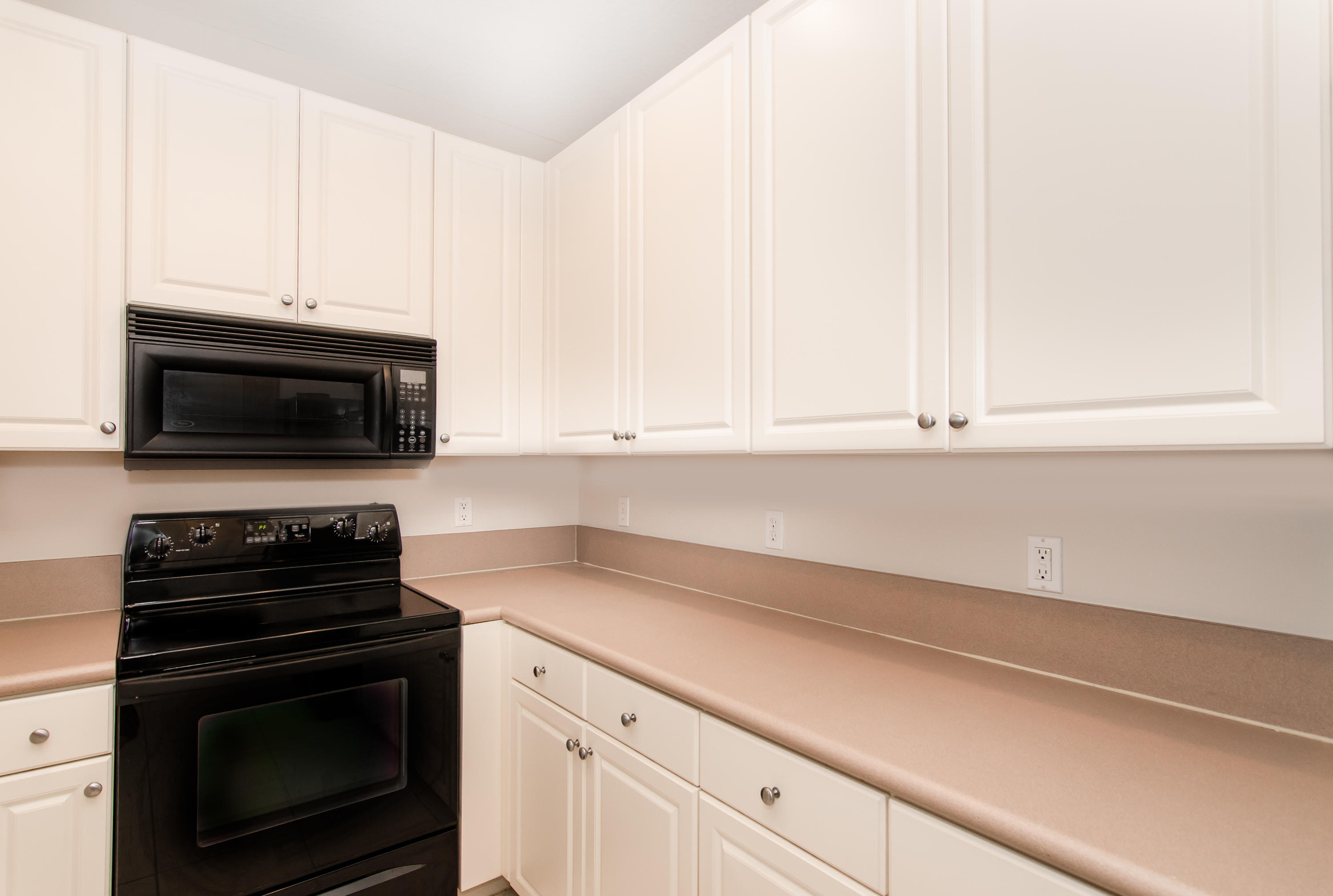 4281 East Main Street Jupiter, FL 33458 - Photo 6 of 37 a kitchen with a stove and a microwave