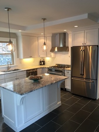 22 Sutherland Road Arlington, MA 02476 - Photo 12 of 30 a kitchen with stainless steel appliances granite countertop a sink a stove a refrigerator a center island and a window