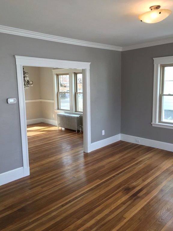 22 Sutherland Road Arlington, MA 02476 - Photo 13 of 30 a view of empty room with wooden floor and fan