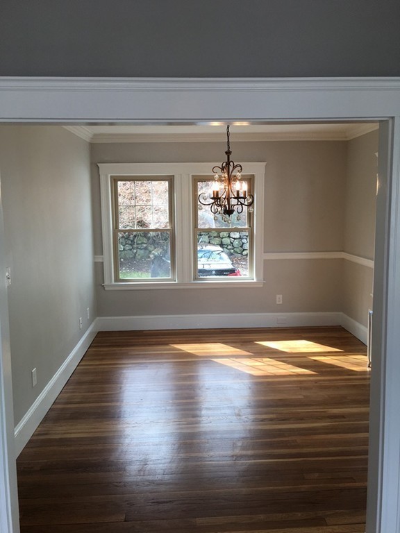 22 Sutherland Road Arlington, MA 02476 - Photo 14 of 30 a view of empty room with window and wooden floor