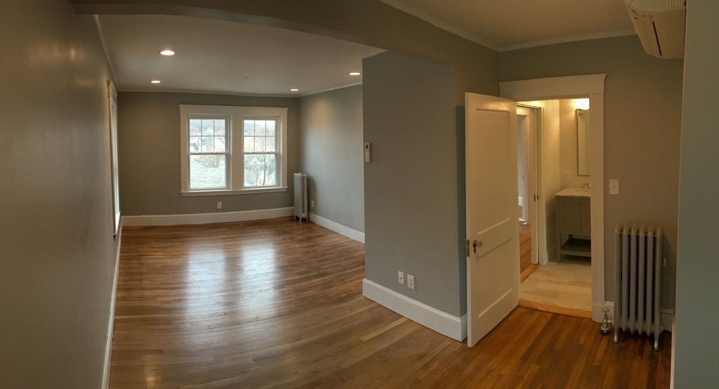 22 Sutherland Road Arlington, MA 02476 - Photo 16 of 30 a view of hallway with window and wooden floor