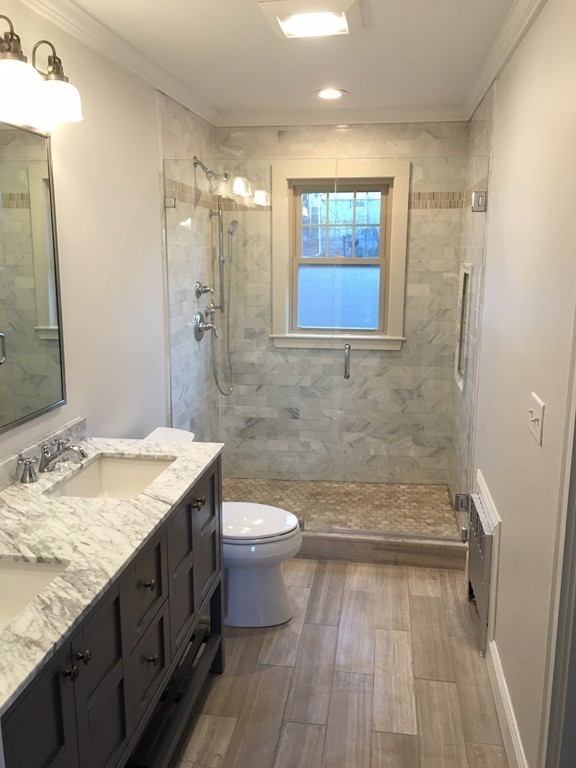 22 Sutherland Road Arlington, MA 02476 - Photo 19 of 30 a bathroom with a granite countertop sink toilet and shower