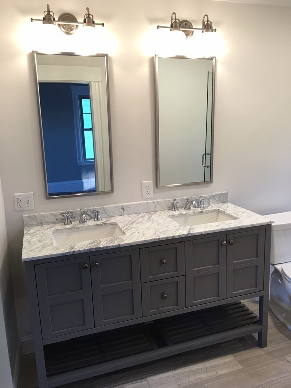 22 Sutherland Road Arlington, MA 02476 - Photo 20 of 30 a bathroom with a sink vanity and mirror