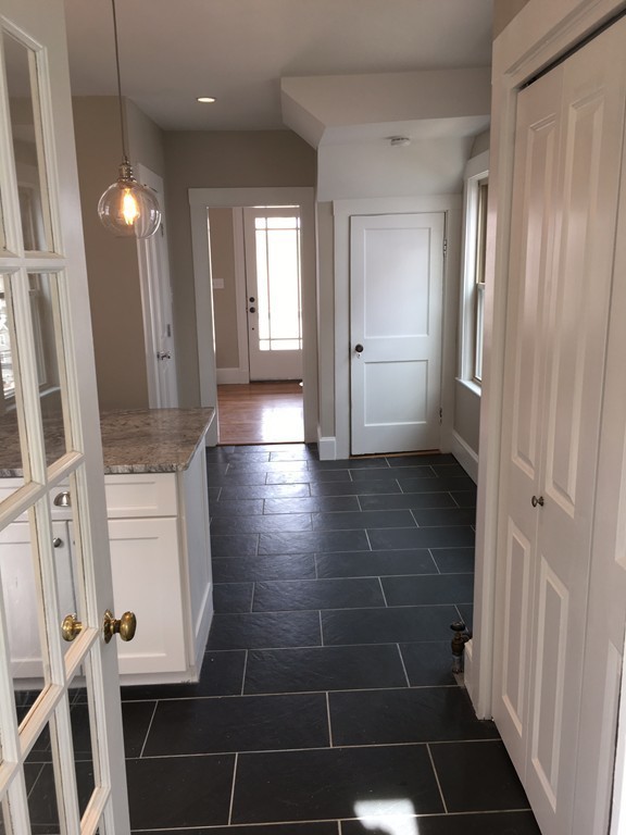 22 Sutherland Road Arlington, MA 02476 - Photo 10 of 30 a view of a hallway with wooden floor and staircase