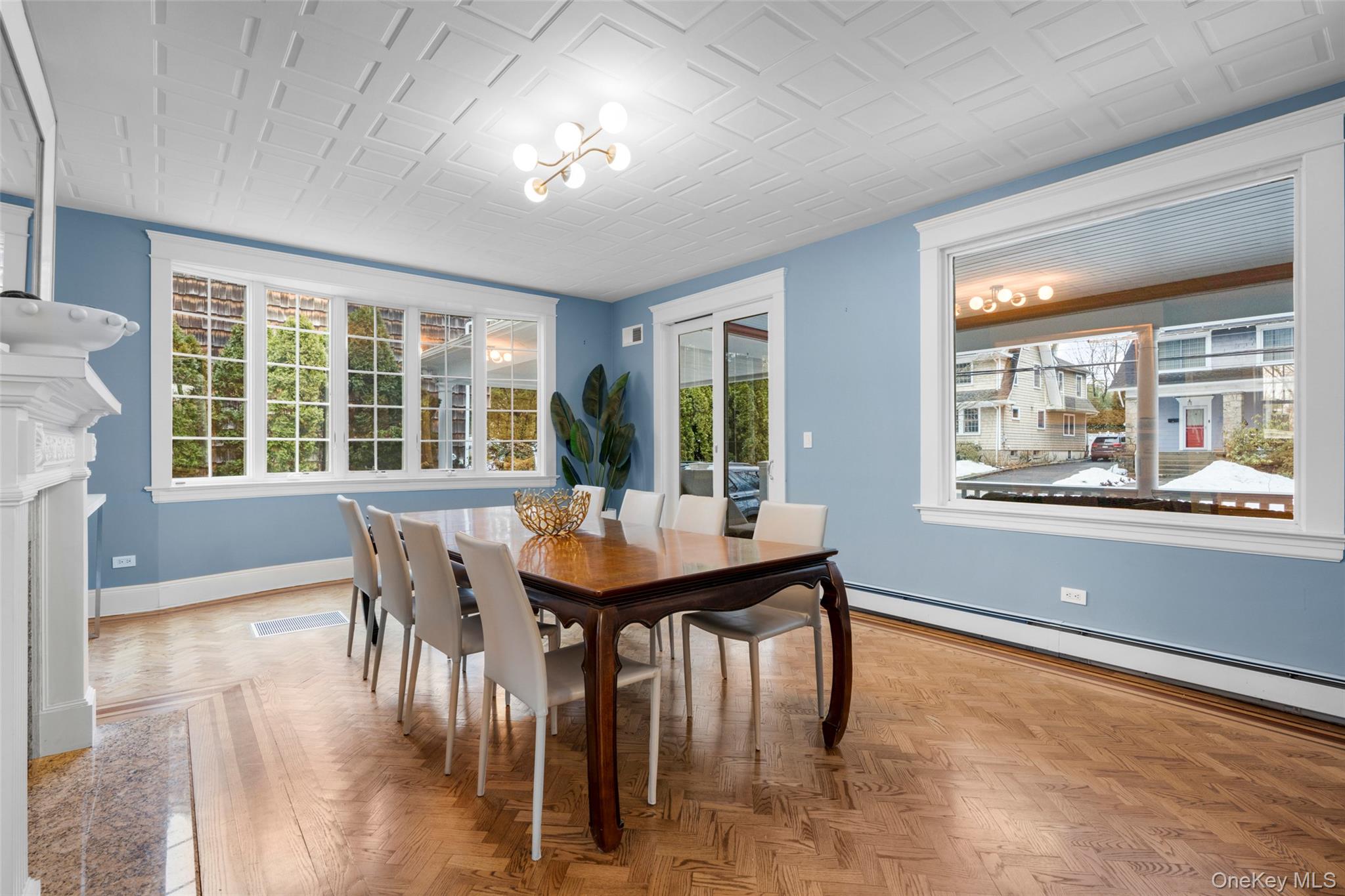 69 Irving Place New Rochelle, NY 10801 - Photo 12 of 46 a view of a dining room with furniture large windows and wooden floor