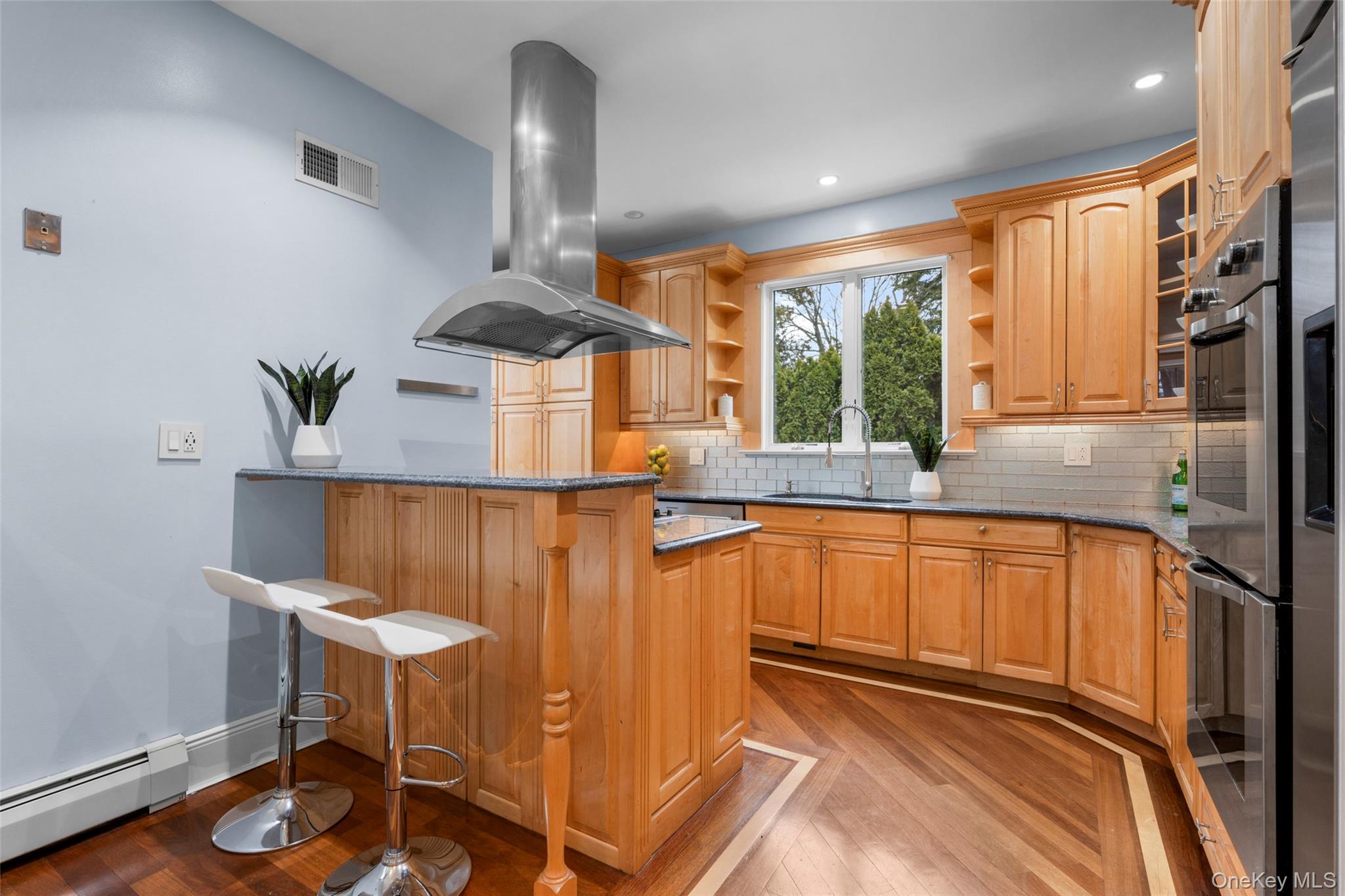 69 Irving Place New Rochelle, NY 10801 - Photo 14 of 46 a kitchen with stainless steel appliances granite countertop a refrigerator a stove and a wooden floors