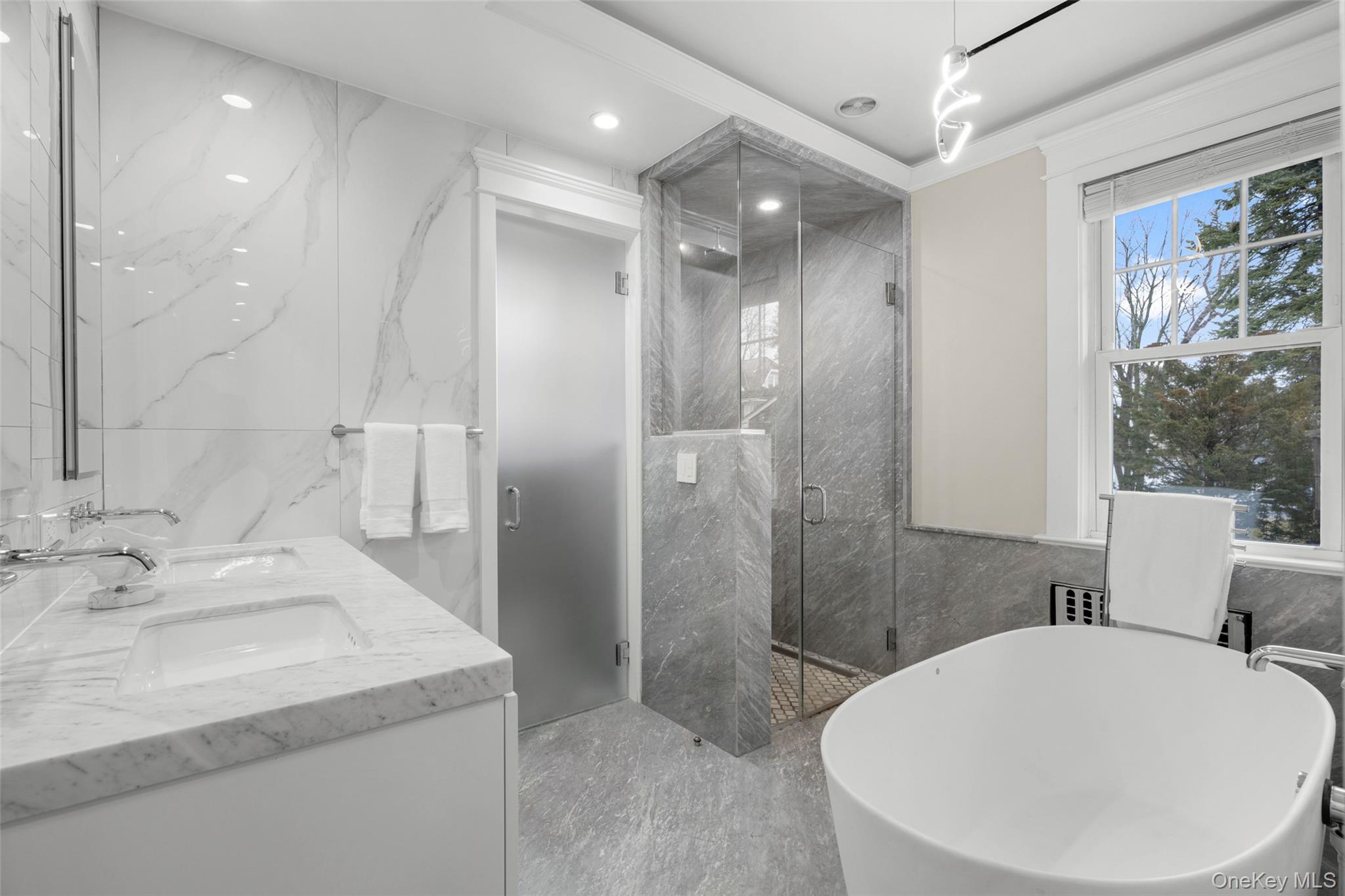 69 Irving Place New Rochelle, NY 10801 - Photo 20 of 46 a bathroom with a sink a toilet and shower