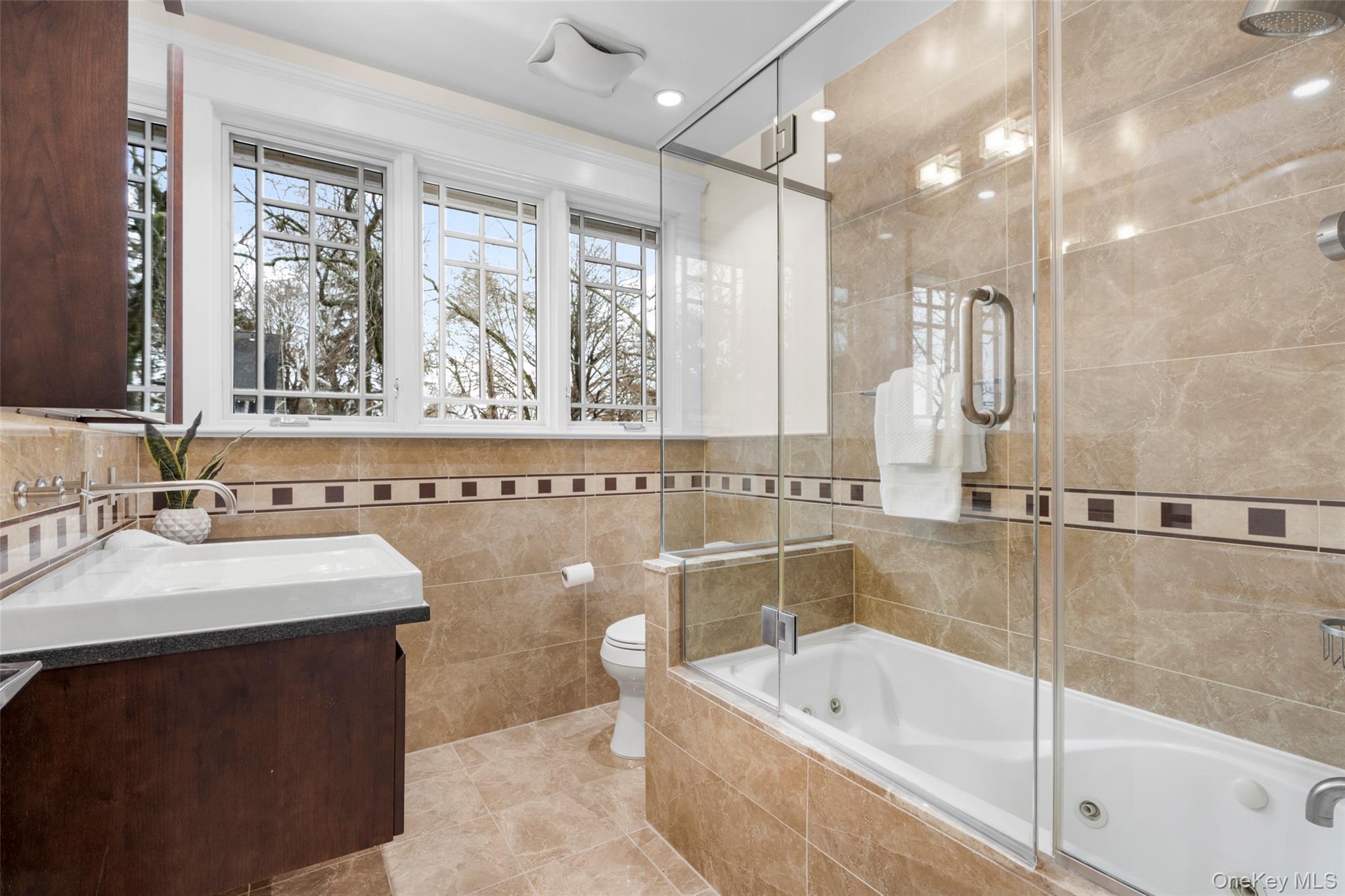 69 Irving Place New Rochelle, NY 10801 - Photo 25 of 46 a bathroom with a bathtub a sink and a shower