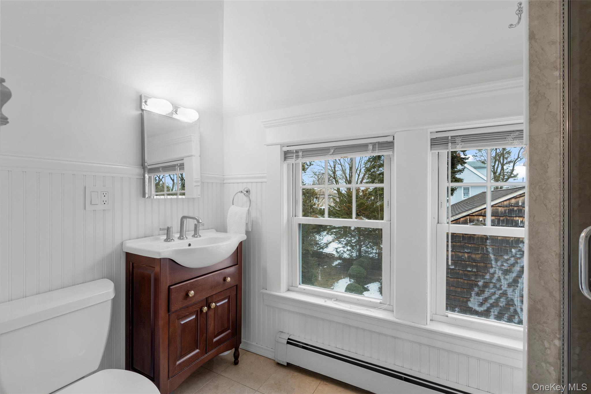 69 Irving Place New Rochelle, NY 10801 - Photo 29 of 46 a bathroom with a toilet a sink and mirror