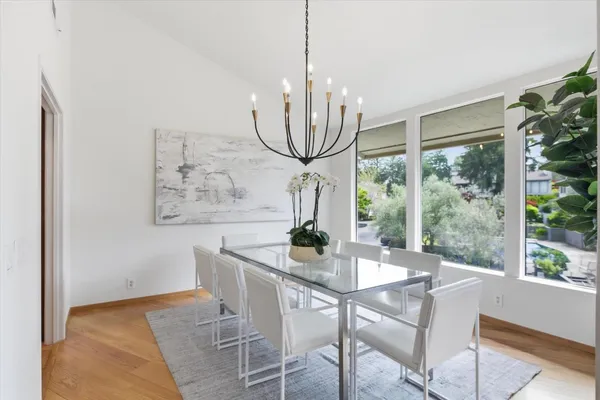 a dining room with furniture and wooden floor