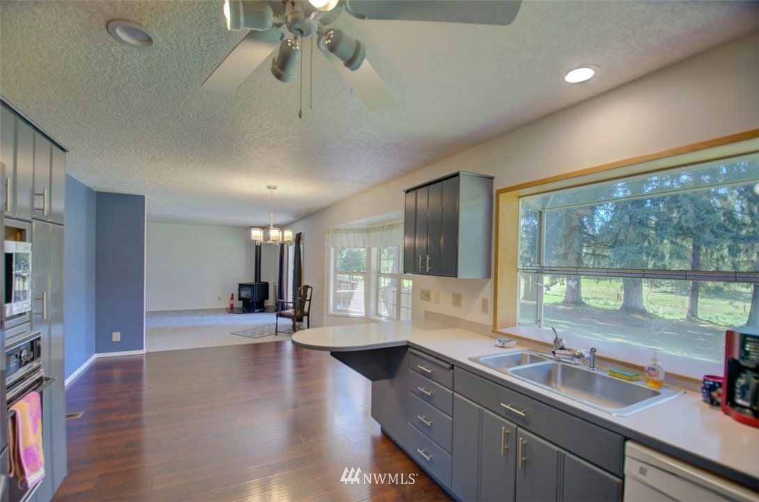 575 Telegraph Road Winlock, WA 98596 - Photo 8 of 30 a kitchen with a large window appliances and cabinets