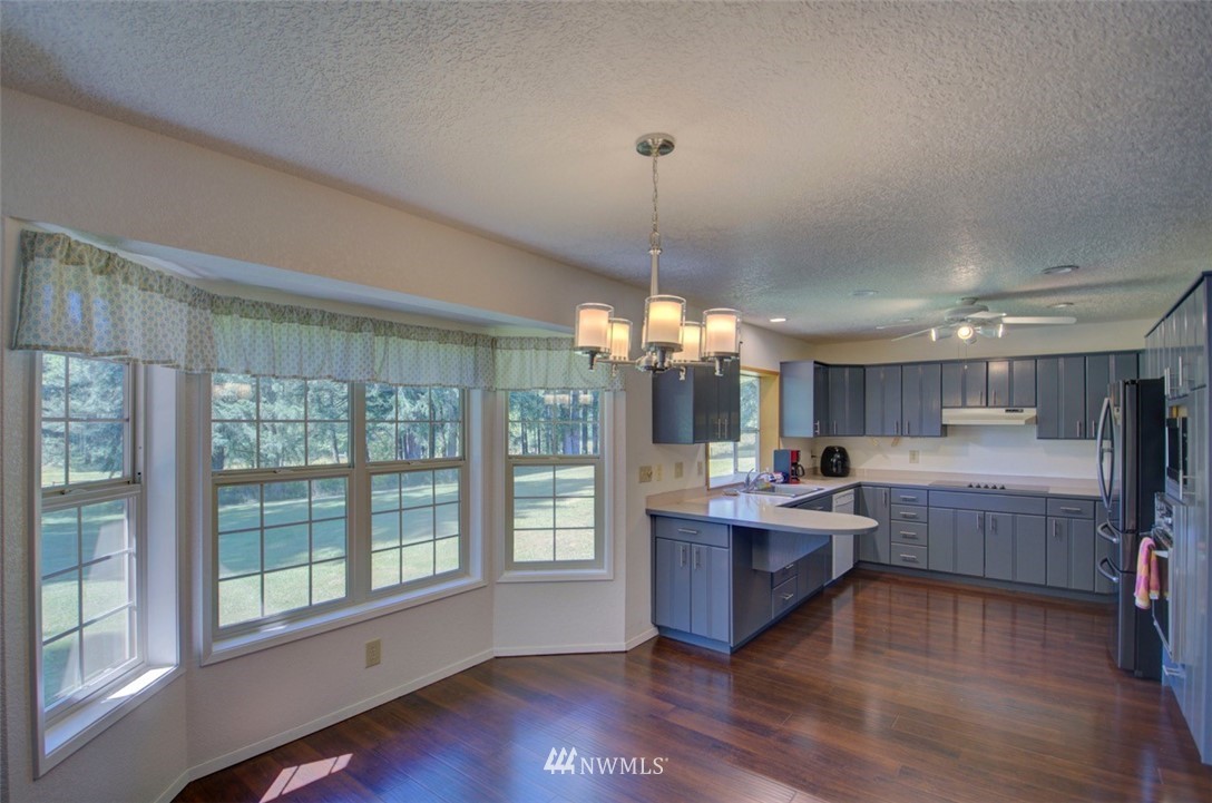 575 Telegraph Road Winlock, WA 98596 - Photo 9 of 30 a kitchen with lots of counter top space and wooden floor