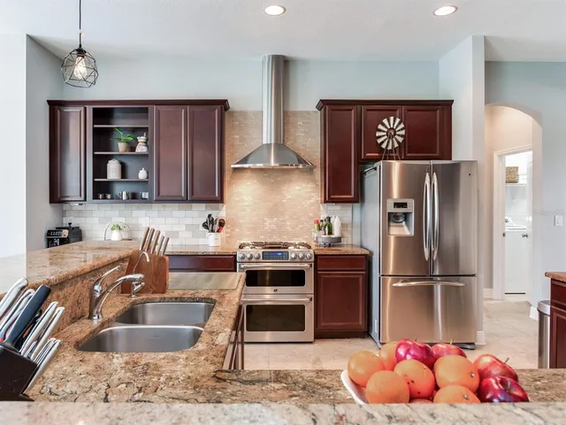 a kitchen with a stove refrigerator and cabinets
