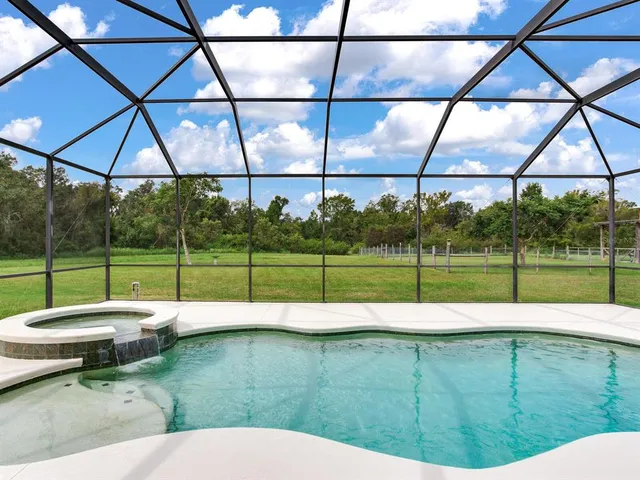 a swimming pool with outdoor seating