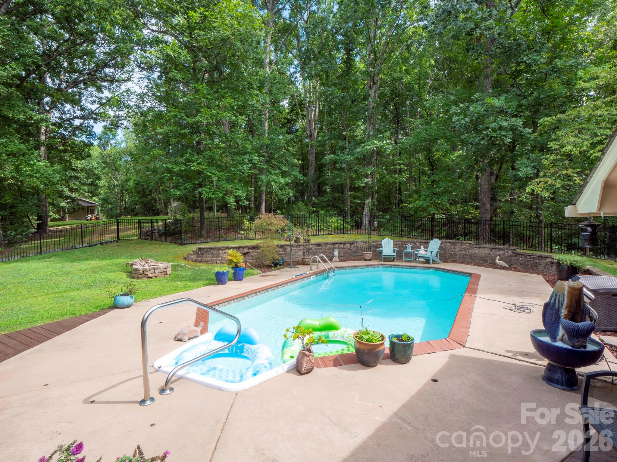 8720 Unionville-Brief Road Monroe, NC 28110 - Photo 13 of 35 a view of a swimming pool and lounge chairs