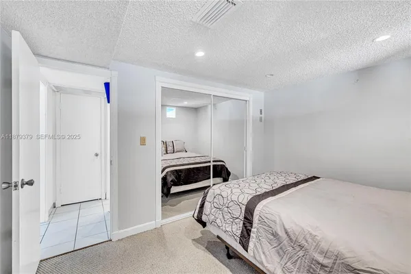 a bedroom with a bed and a closet