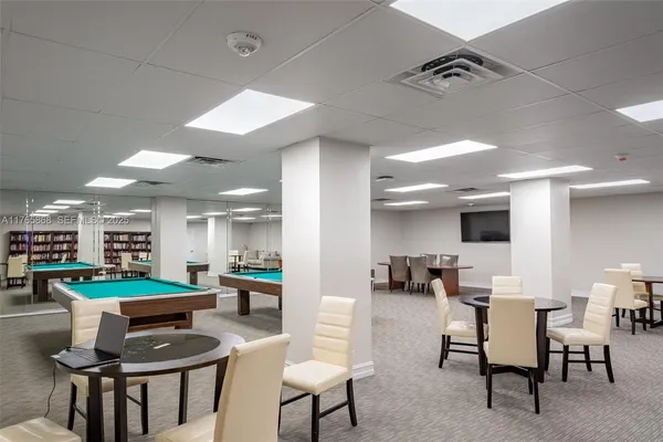 a kitchen with stainless steel appliances kitchen island granite countertop a table and chairs