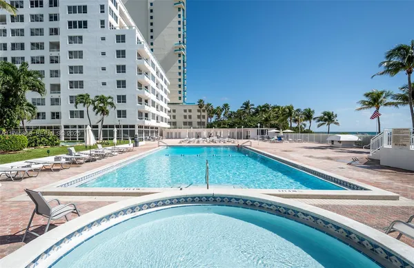 a view of a swimming pool with a lawn chairs