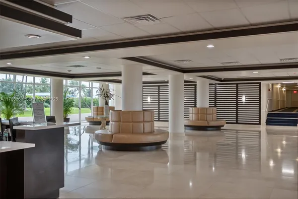 a living room with furniture and large windows