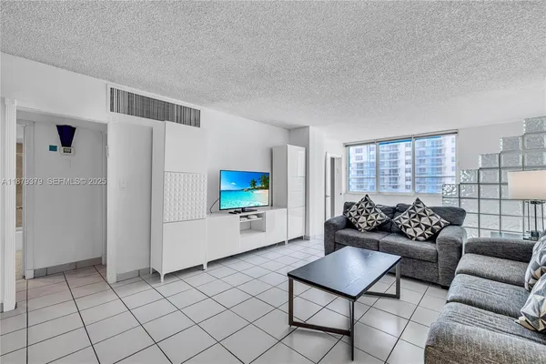 a living room with furniture and a flat screen tv
