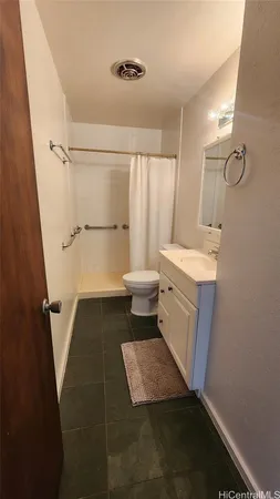 a bathroom with a sink a toilet a mirror and shower