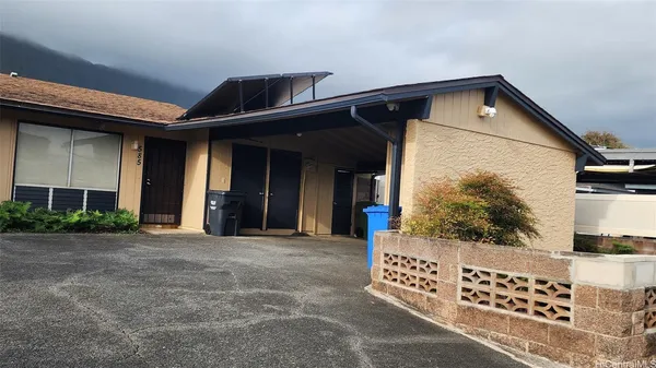 a front view of a house with plants