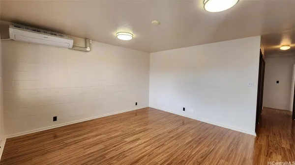a view of room with wooden floor
