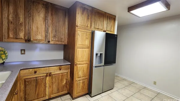a kitchen with granite countertop cabinets and refrigerator