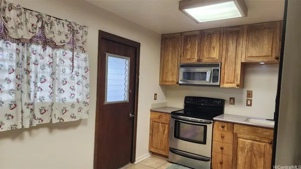 a kitchen with a cabinets and a stove top oven