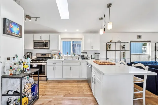 a kitchen with a stove a sink and a refrigerator