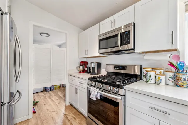 a kitchen with stainless steel appliances a stove a microwave and cabinets