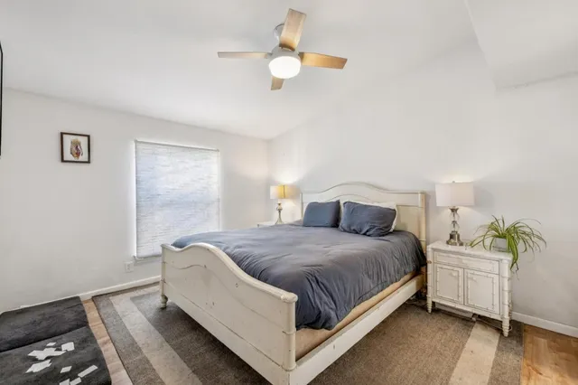 a living room with a bed furniture and a window