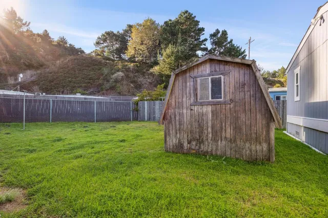 a view of a backyard with wooden fence