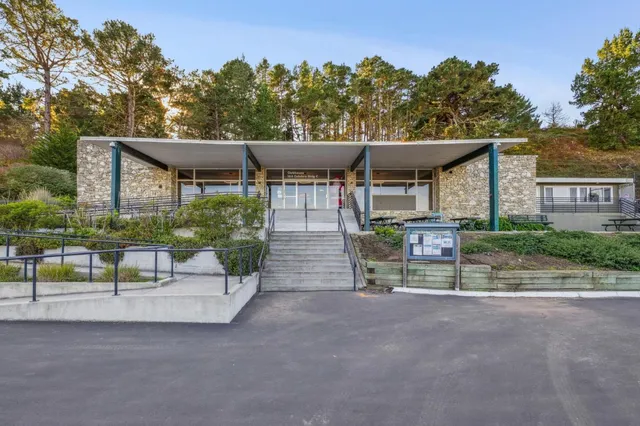 a view of a chairs and table in the back yard of the house