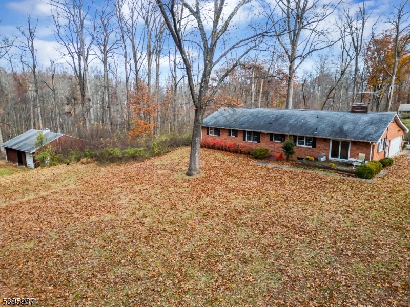 a view of a house with a yard and sitting area