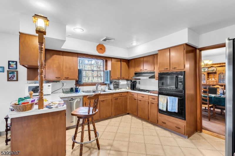 106 Rocktown Road Ringoes, NJ 08551 - Photo 15 of 36 a kitchen with stainless steel appliances granite countertop a stove top oven a sink dishwasher and cabinets