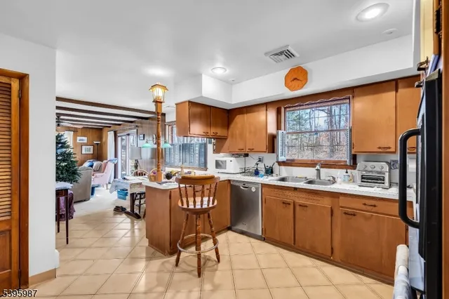 a kitchen with a sink dining table and chairs