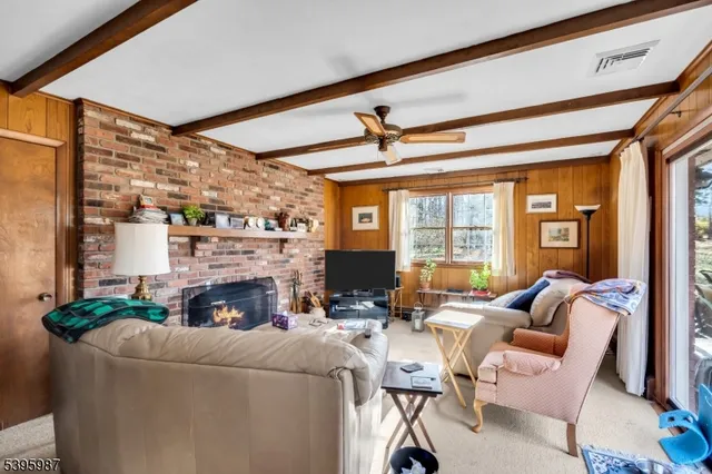 a living room with fireplace furniture and a floor to ceiling window