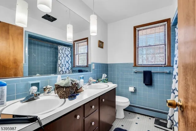 a bathroom with a sink a toilet and mirror