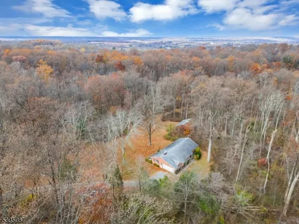 an aerial view of a house with a yard and lake view