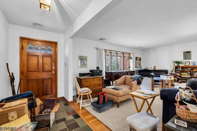 a living room with furniture a rug and a window