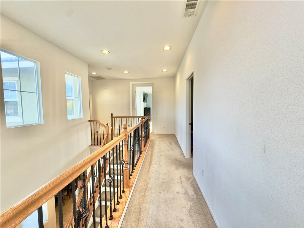 11265 Runyan Road Beaumont, CA 92223 - Photo 75 of 138 a view of a hallway with wooden floor and stairs