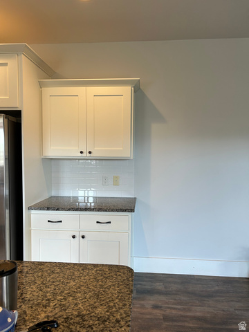175 North 100th West Centerfield, UT 84622 - Photo 14 of 32 White shaker cabinetry with crown molding, granite-finish countertops, white subway tile backsplash, and dark wood-finish flooring