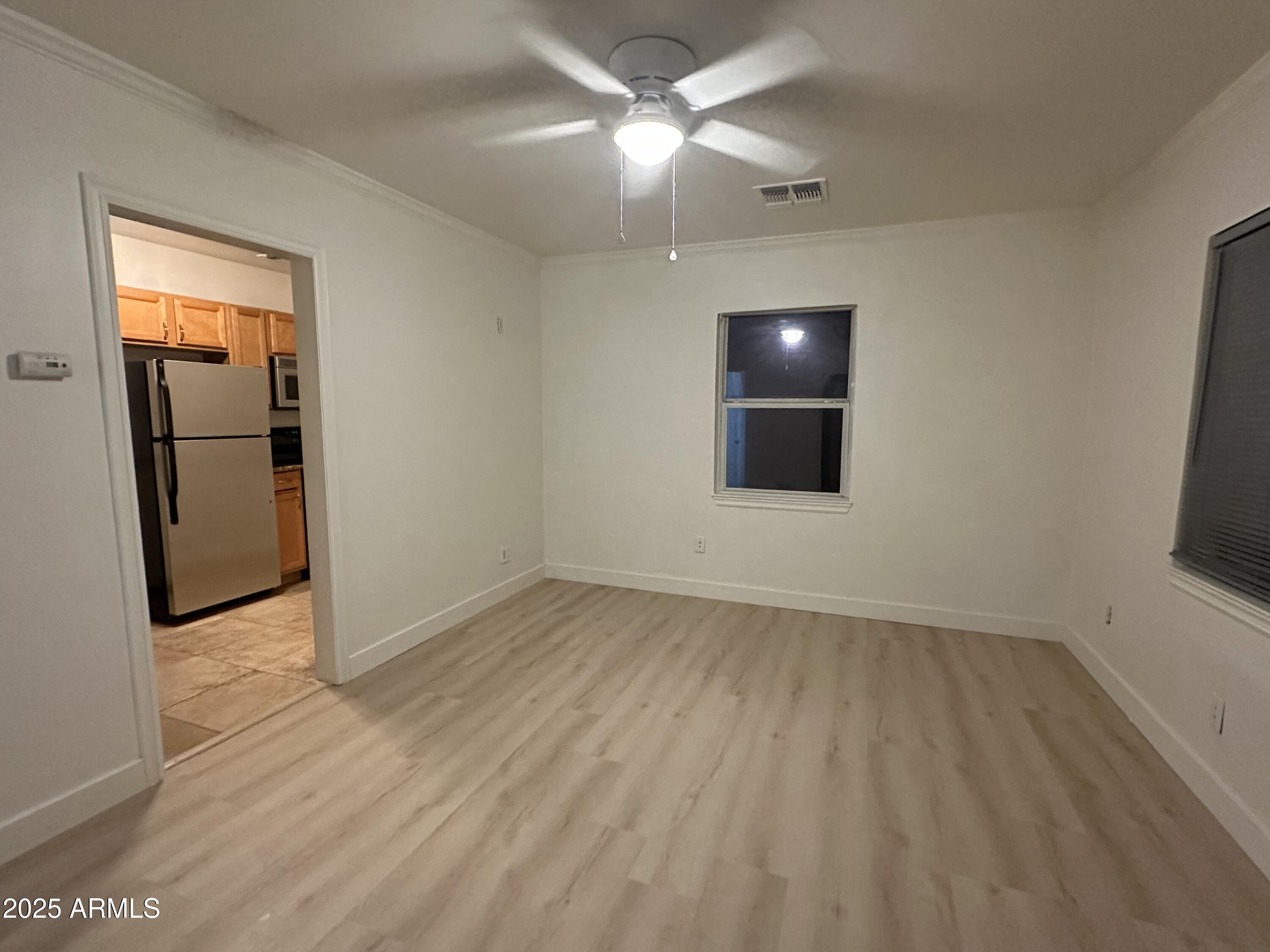 636 North 4th Avenue, Unit 3 Phoenix, AZ 85003 - Photo 5 of 8 an empty room with wooden floor and mirror